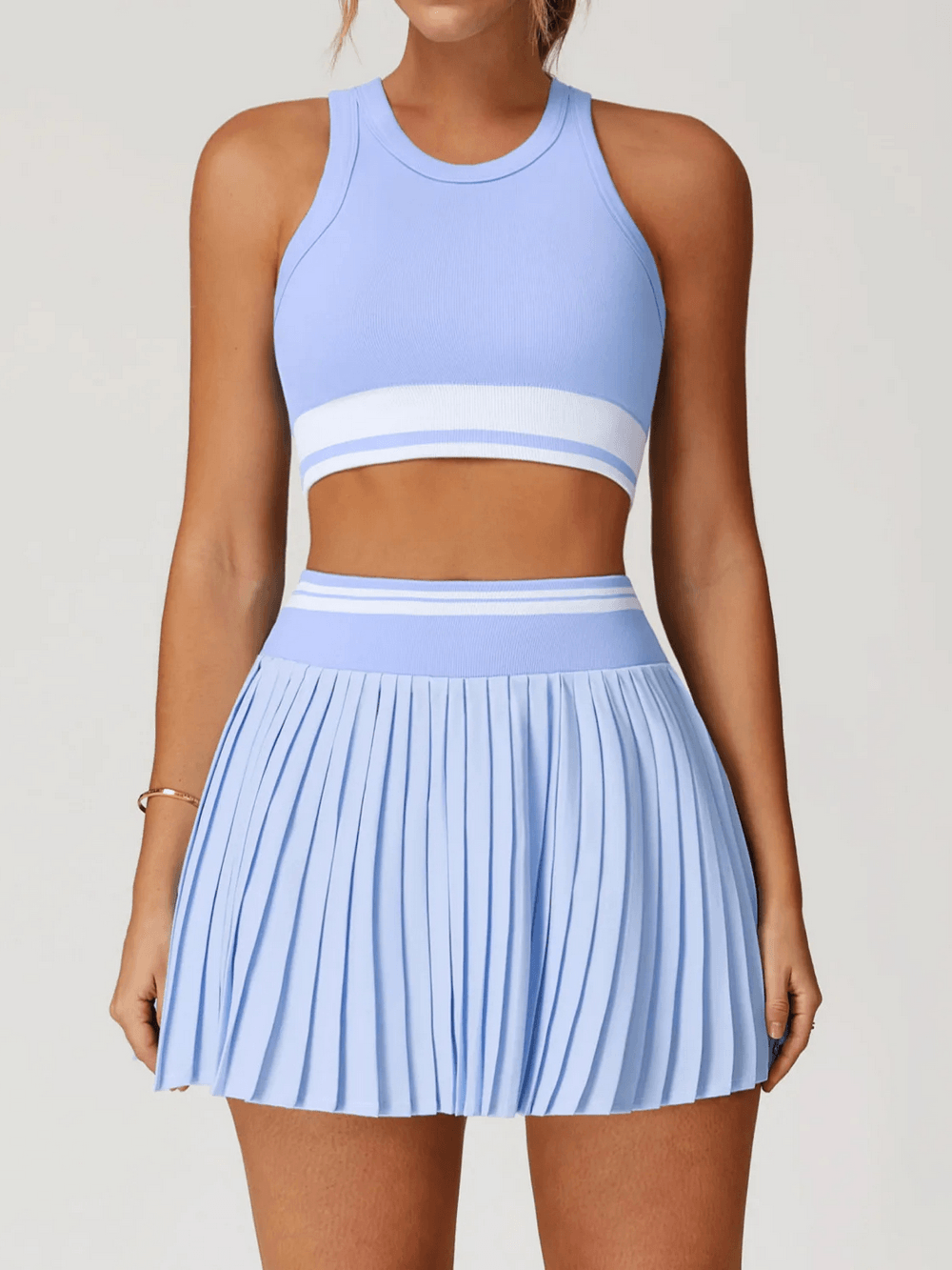 Pleated Tennis Skirt and Racerback Crop Top Set - SF4582 in light blue color, stylish and sporty outfit for tennis enthusiasts.