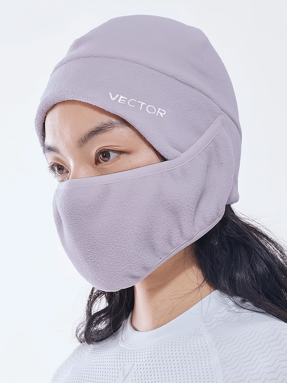 Woman wearing windproof thermal polar fleece balaclava with face and ear protection, featuring a sleek logo.