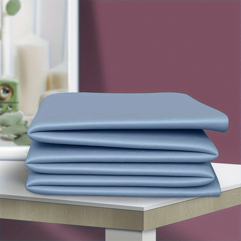 Folded blue yoga mat on table, perfect for portable fitness sessions, showcasing its lightweight and compact design.