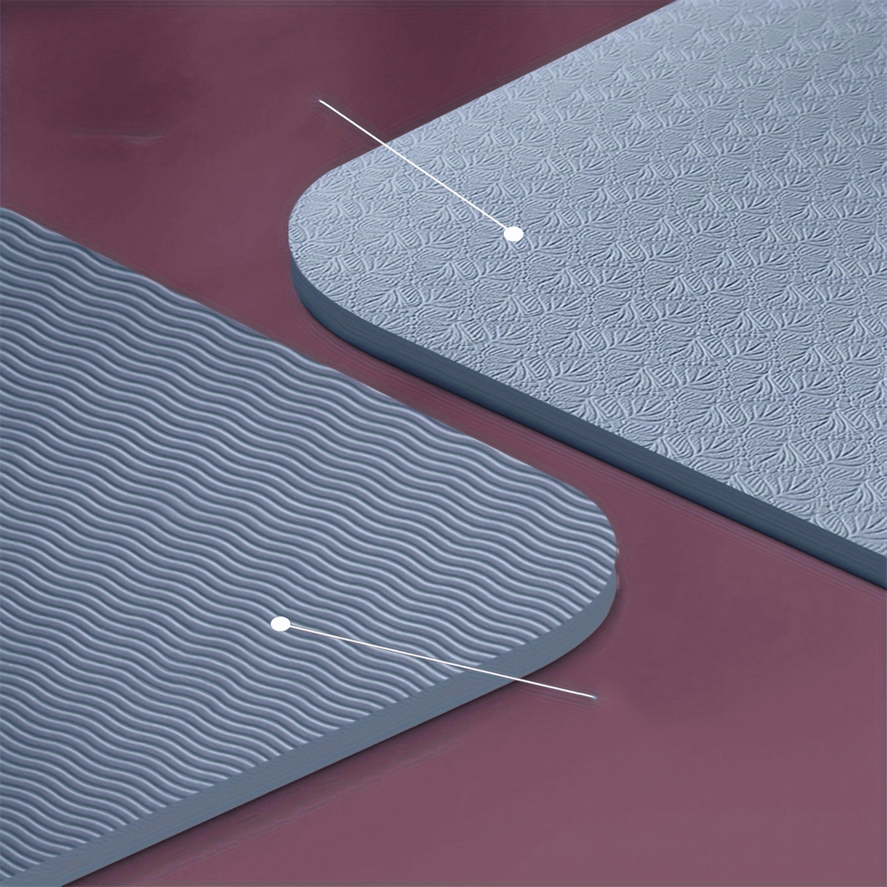 Close-up of a gray foldable non-slip yoga mat with textured surface, ideal for exercises at home or gym.