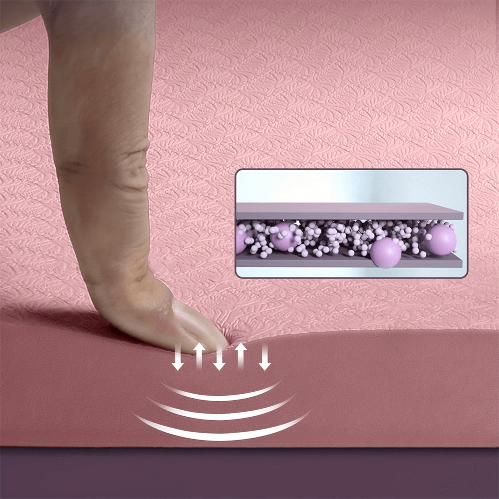 Finger pressing into a pink yoga mat showing non-slip texture and foam cushioning layers, ideal for stability during workouts.