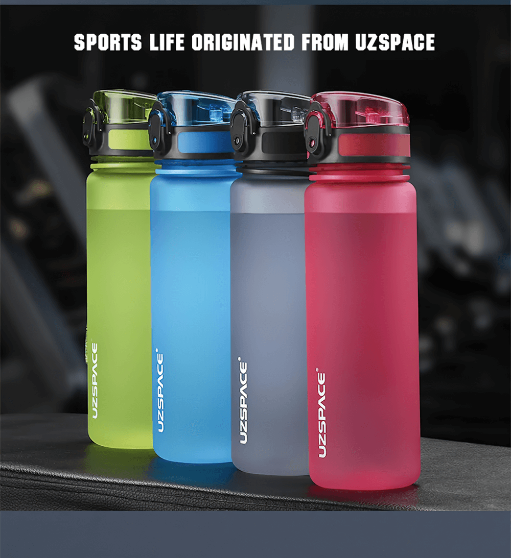 Colorful sports water bottles in a gym setting, showcasing leak-proof design and convenient carrying strap.