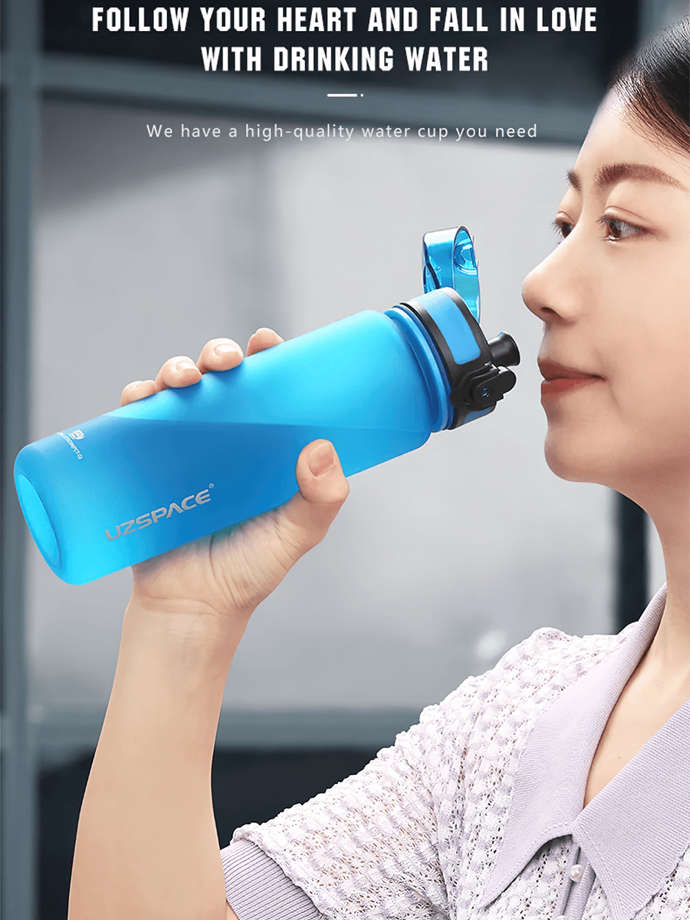 Woman drinking from a blue portable leak-proof sports water bottle with easy-open lid and strap, perfect for hydration on-the-go.