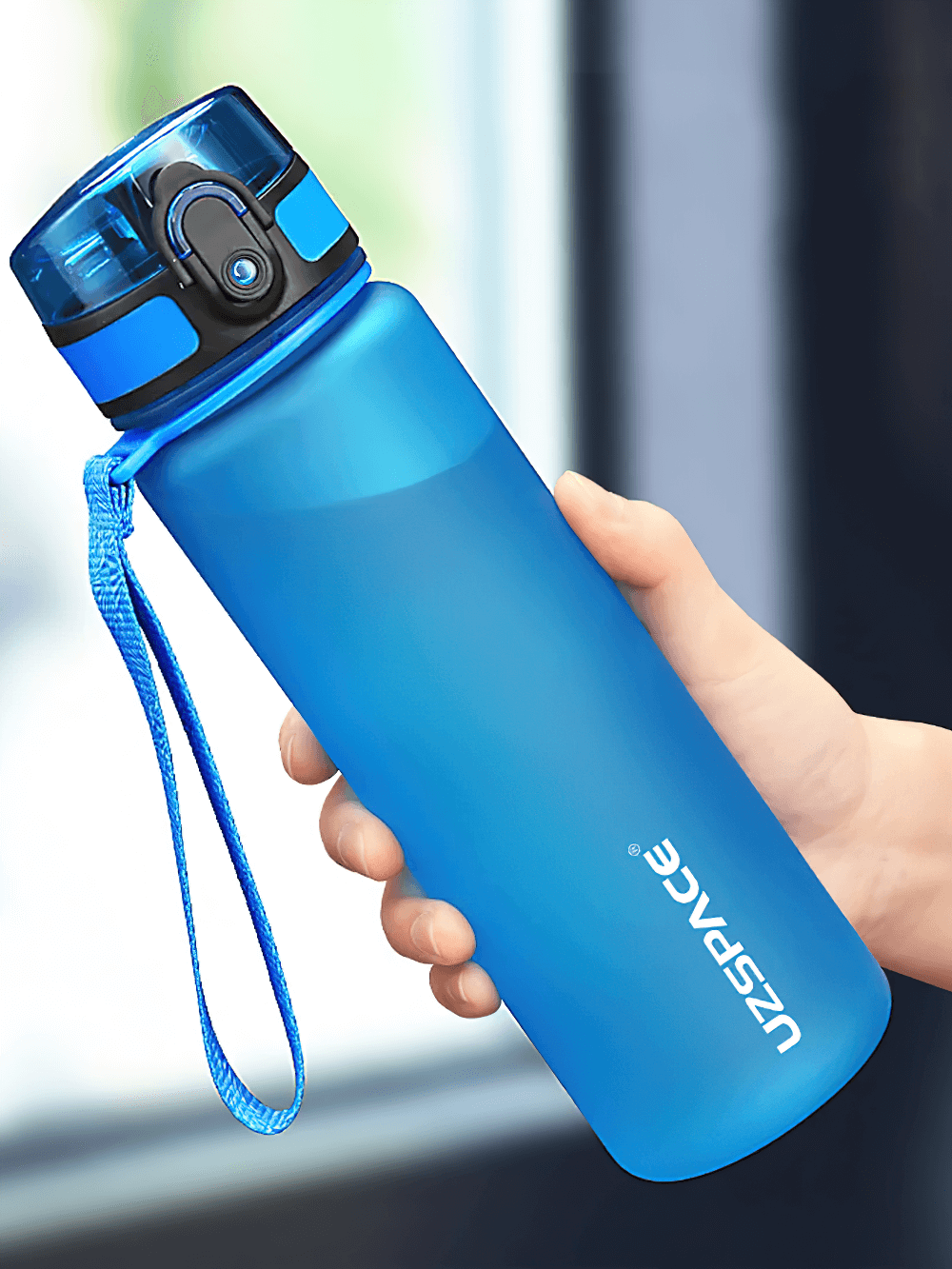 Hand holding a blue portable leak-proof sports water bottle with easy-open lid and strap, made of durable Tritan material, model SF3068.