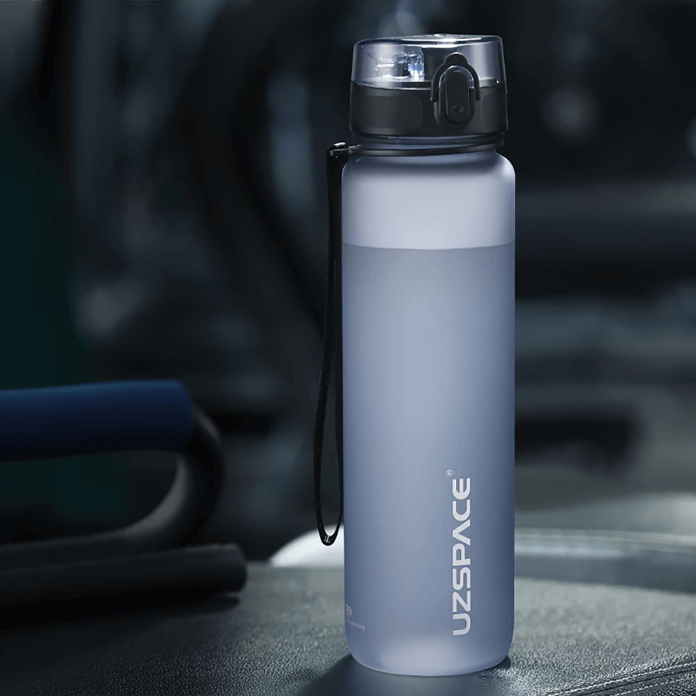 Portable leak-proof sports water bottle with strap, made from durable Tritan material. Perfect for outdoor activities and hydration.