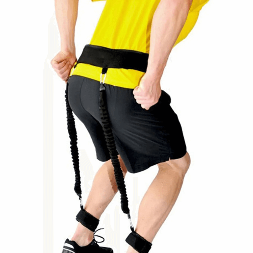Man using portable tube resistance bands with ankle cuffs and waist belt for gym workouts, enhancing leg and core strength training.