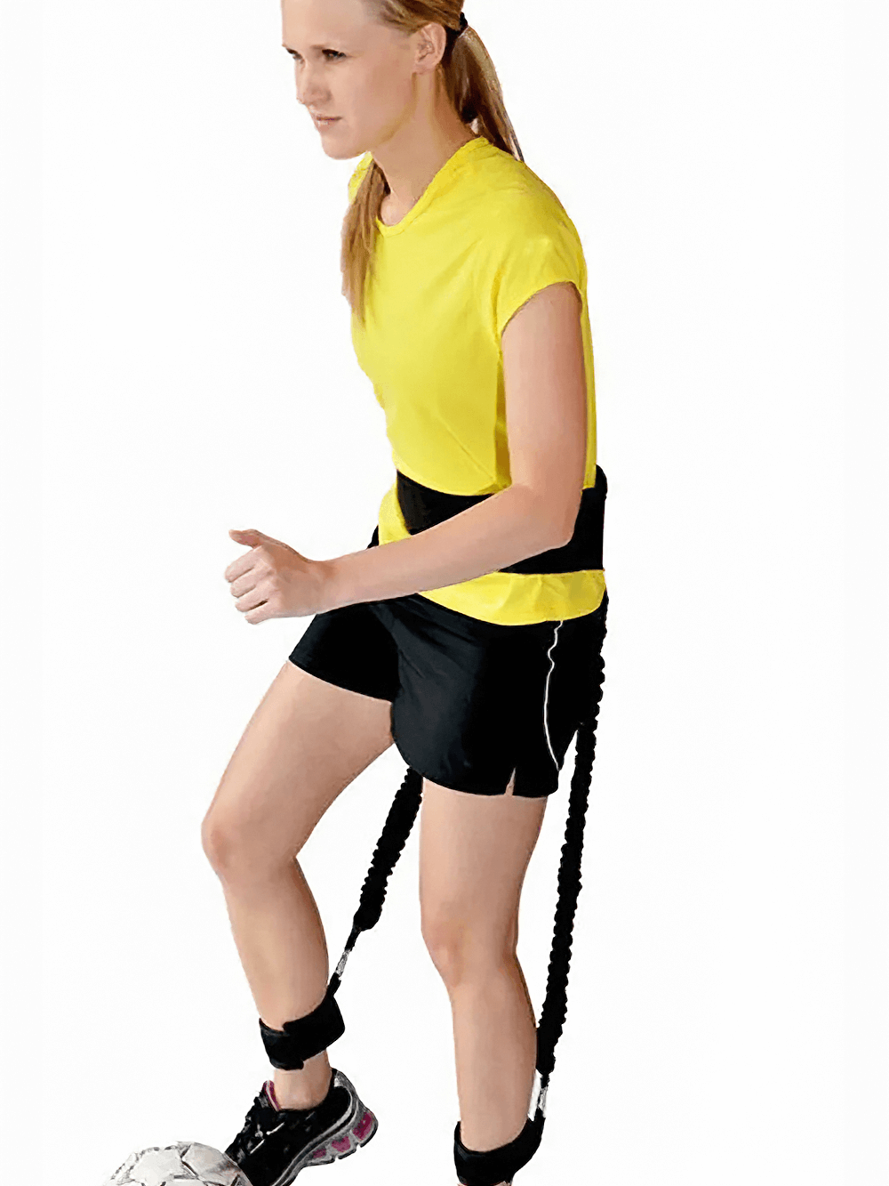 Woman using portable resistance band set with ankle cuffs for a dynamic workout.