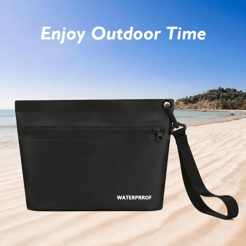 Sleek black waterproof swim bag with zip closure on a sunny beach background, perfect for outdoor adventures.