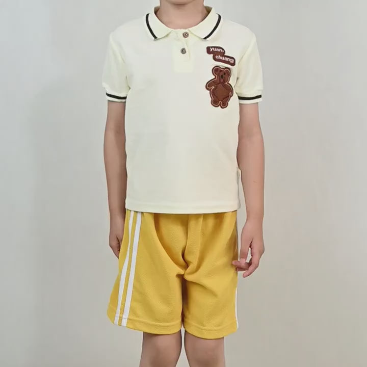 Child wearing yellow Kids Athletic Shorts with Side Stripes Design - SF3766, paired with a teddy bear patch polo shirt.