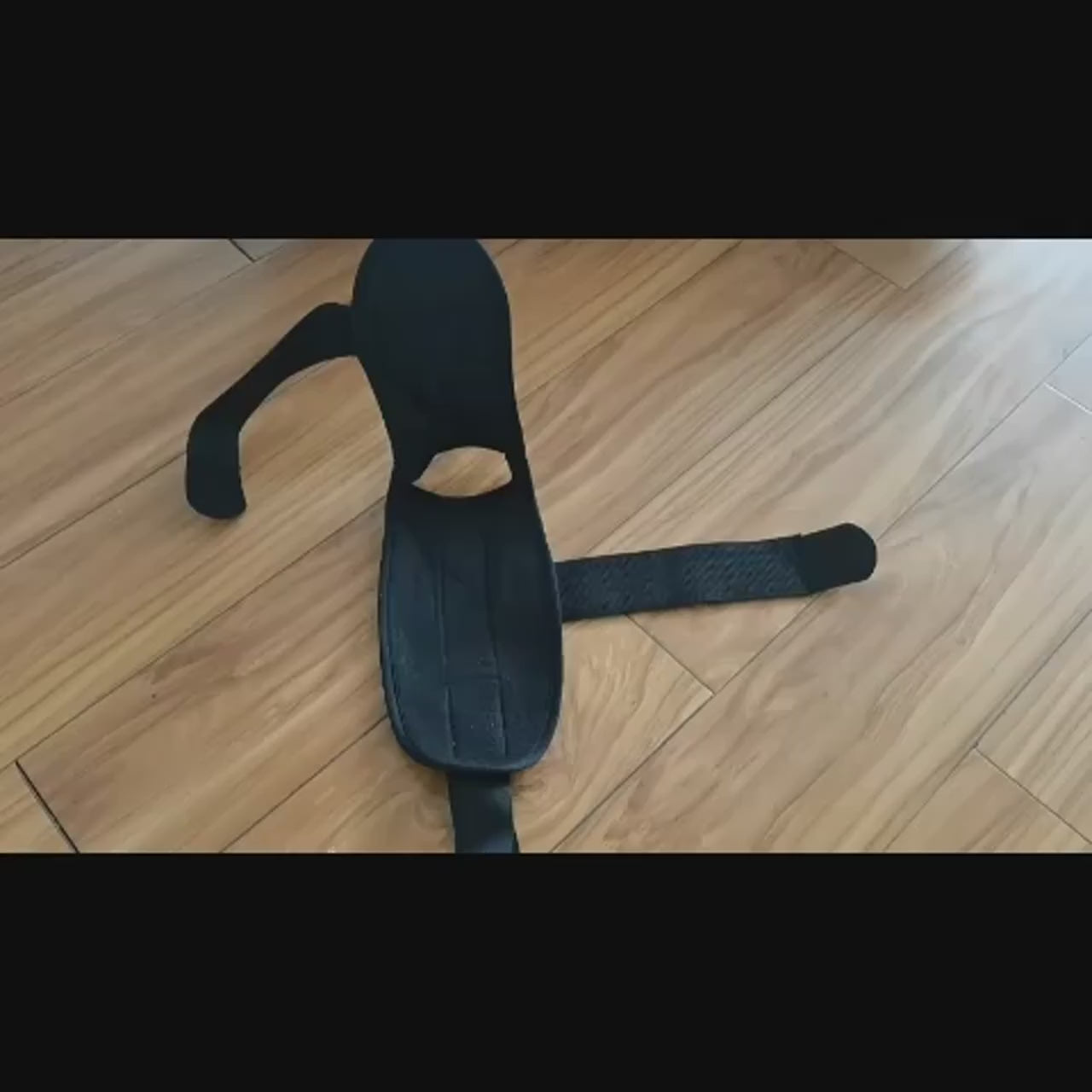 Adjustable foot stretching band SF3319 on wooden floor, ideal for yoga and rehabilitation to enhance flexibility and balance.