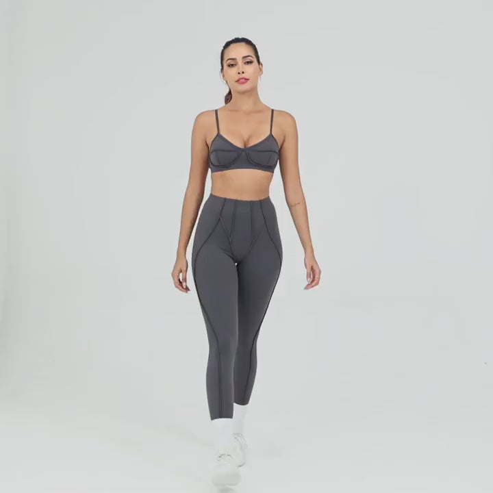Woman modeling Exposed Seam High Waist Yoga Leggings - SF4056 in grey, showcasing fitness fashion with sleek silhouette and supportive high waist.