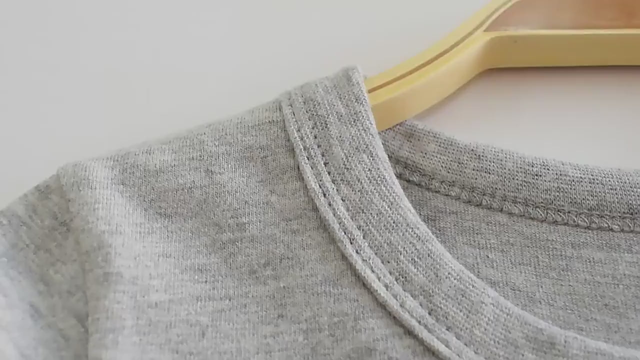 Close-up of a grey crewneck design on Boys Cotton Long-Sleeved Top with Letter Print - SF3608 hanging on a wooden hanger.