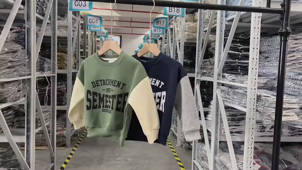 Trendy kid's sweatshirts with 'Detachment Semester' print in green and navy, featuring sporty design and color block sleeves.