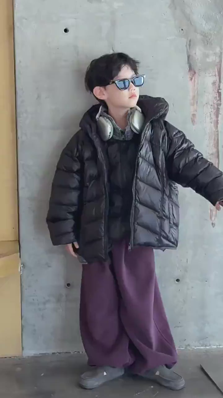 Boy wearing Boys Hooded Down Puffer Jacket With Zipper - SF3638, black jacket with hood, standing cool with sunglasses and headphones.