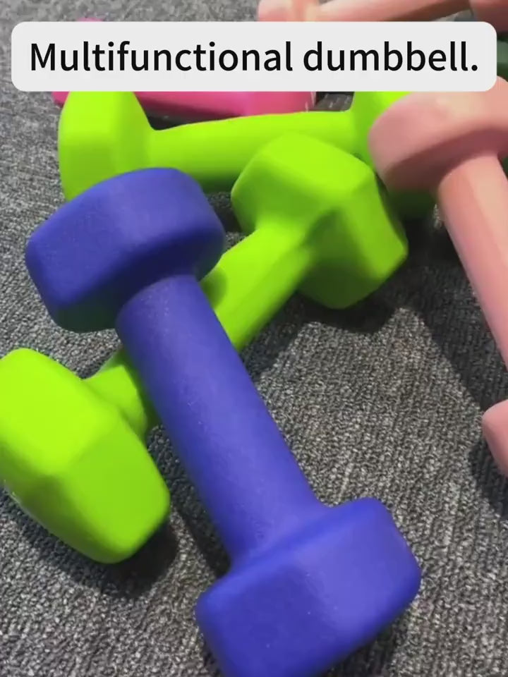 Colorful dumbbell set on grey mat, ideal for strength training and yoga at home or gym.