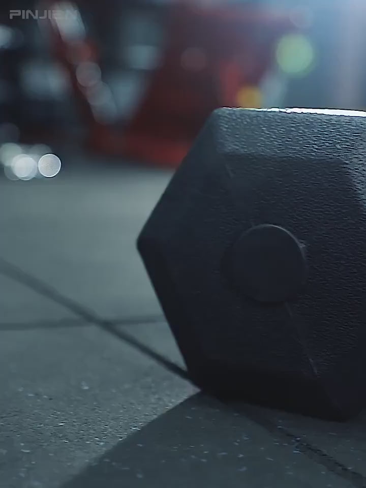 Hexagonal dumbbell on gym floor, perfect for strength training and anti-roll stability. Durable PVC exterior.