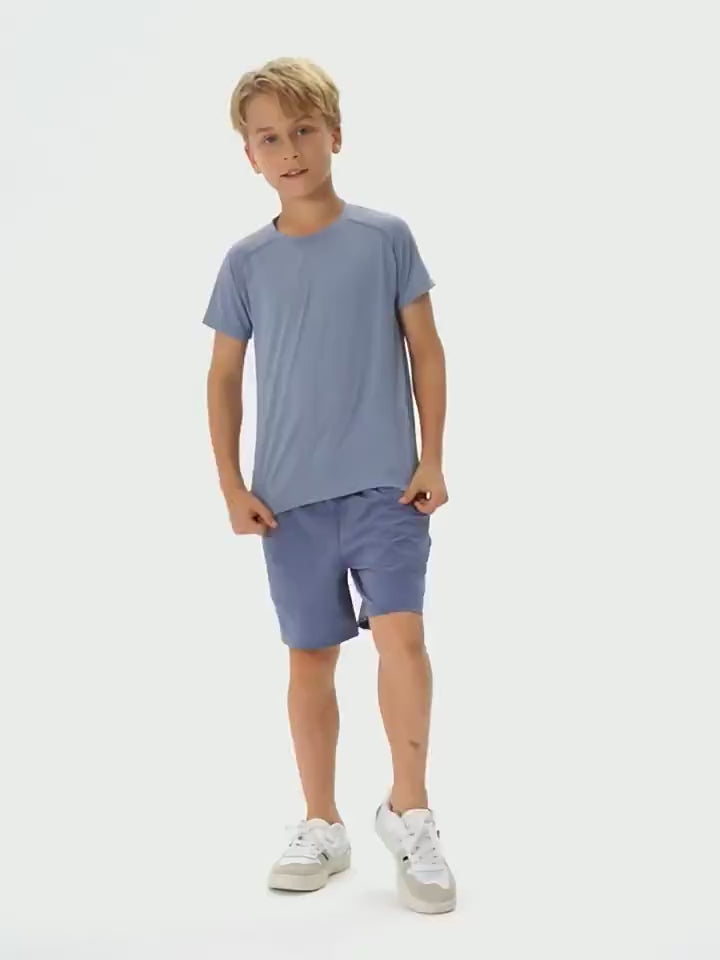 Young boy wearing Kids Quick Dry Sports Crewneck Training T-Shirt - SF3854, standing confidently in activewear, ready for play.