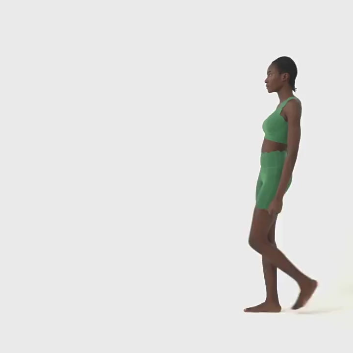 Model wearing One-Shoulder Scallop Seamless Yoga Sports Bra - SF4012 in green showcased in athletic pose.