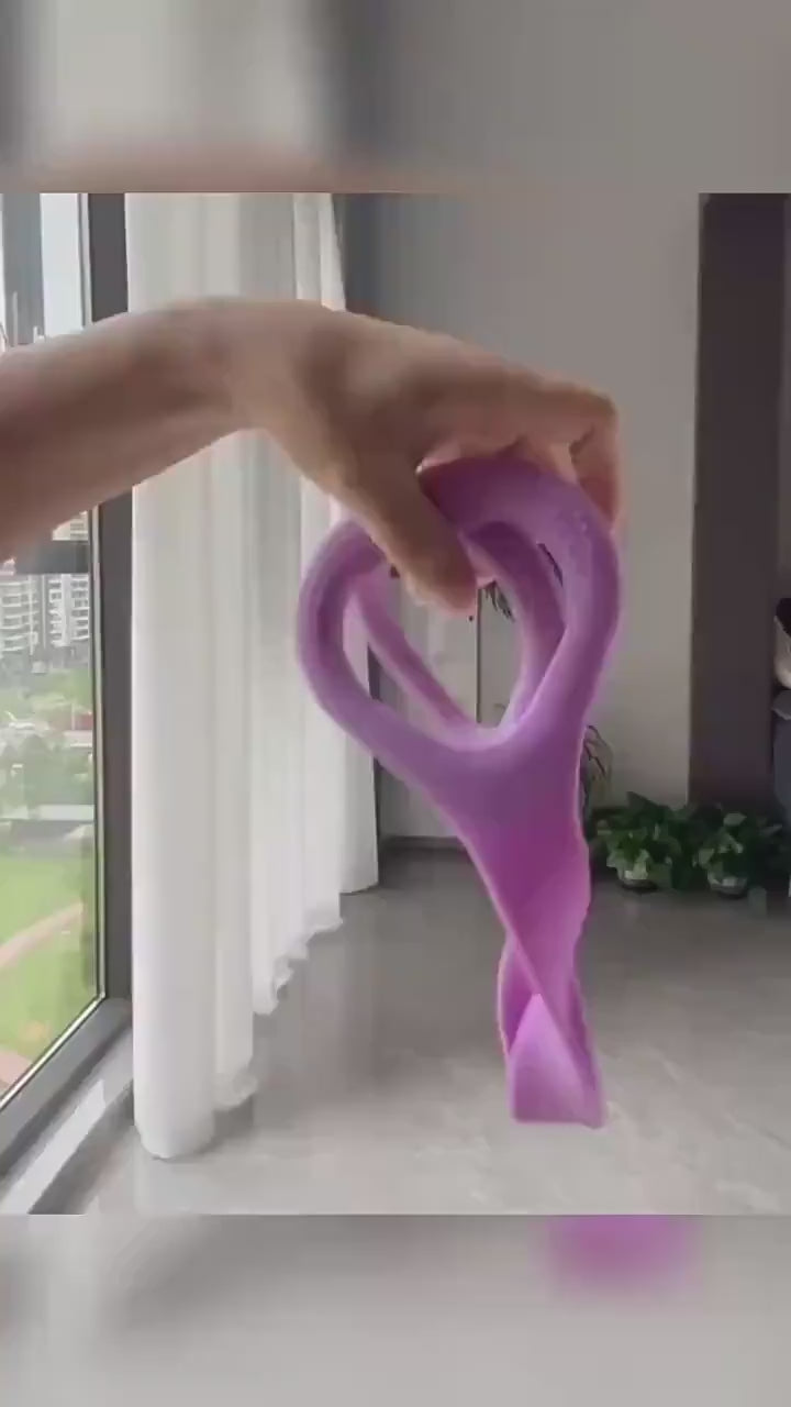 Hand holding a purple yoga stretch band for flexibility and posture exercises at home.