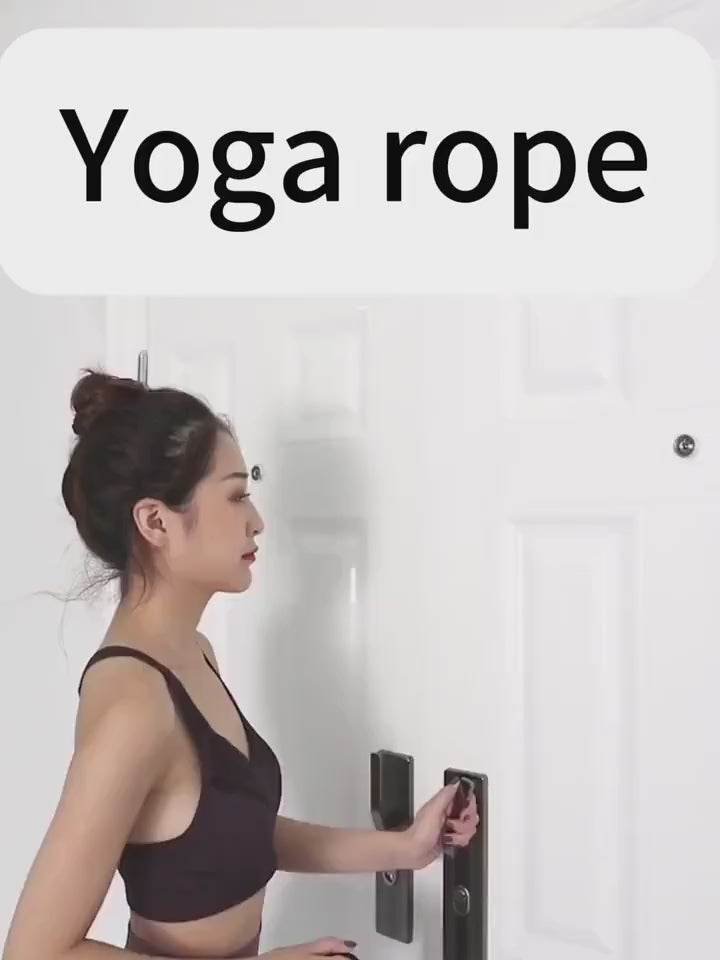 Woman preparing to use aerial yoga rope for home gym stretching and inversion therapy.