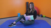 Woman holding Gradient Resistance Band SF3410 on exercise mat, ideal for squats and stretching with elastic anti-slip loop.