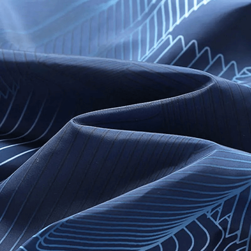 Close-up of blue printed fabric with abstract patterns used in men's windbreaker jacket.