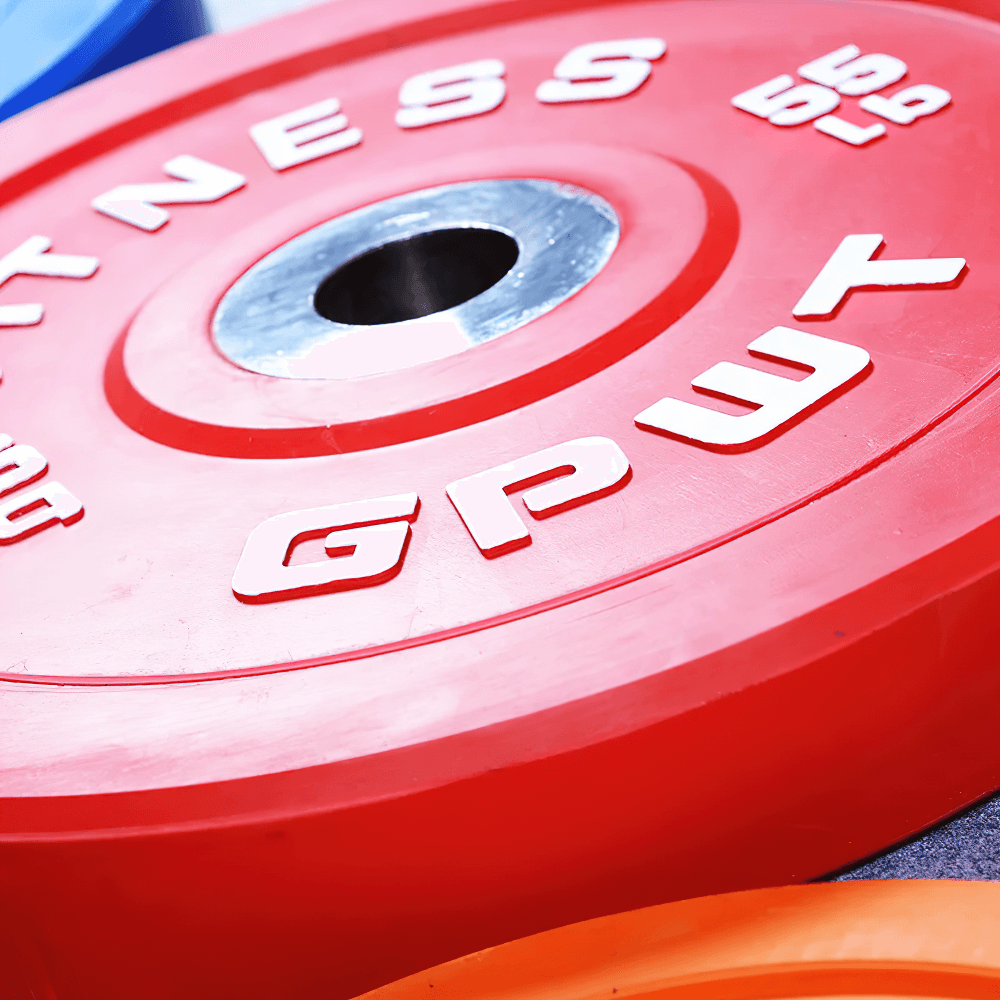 Durable color-coded rubber barbell weight plate for gym use, designed for strength training and versatile barbell fitting.