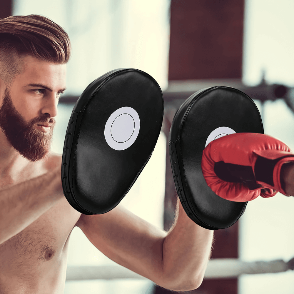 PU leather boxing focus mitts SF3154 used in gym training for kickboxing and Muay Thai, featuring target print and red boxing gloves.
