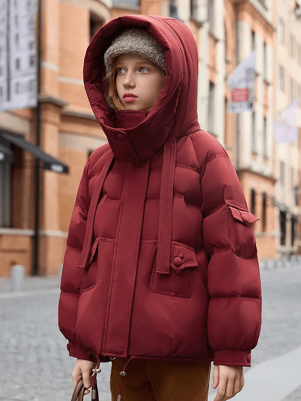 Child wearing a red puffer jacket with oversized hood and pockets - SF3628, perfect for cold weather and street style.