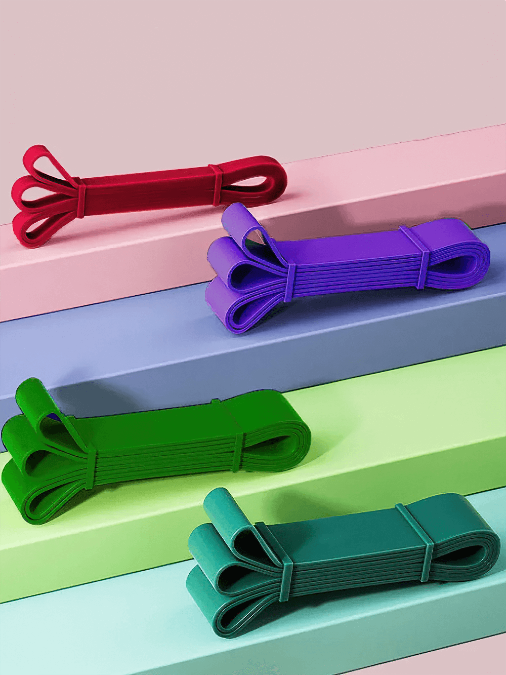 Colorful pull up resistance bands for stretching and Pilates on colorful background. Ideal for home workouts and fitness exercises.