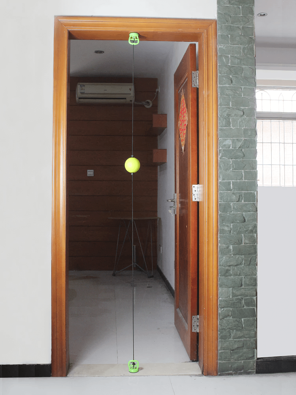 Doorway boxing reflex ball setup for speed and agility training, with durable ball and headband for solo practice.