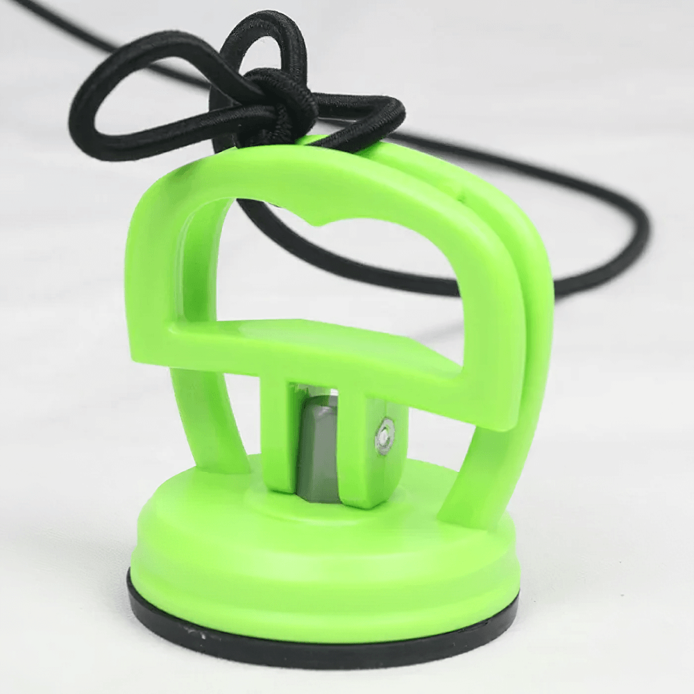 Green suction cup tool with black handle for versatile lifting and holding tasks on smooth surfaces.