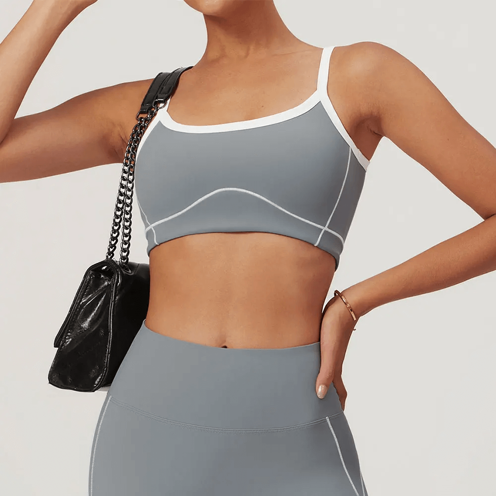 Women's stylish push-up sports bra for yoga and fitness, shown in sleek gray with white accents, ideal for active lifestyles.