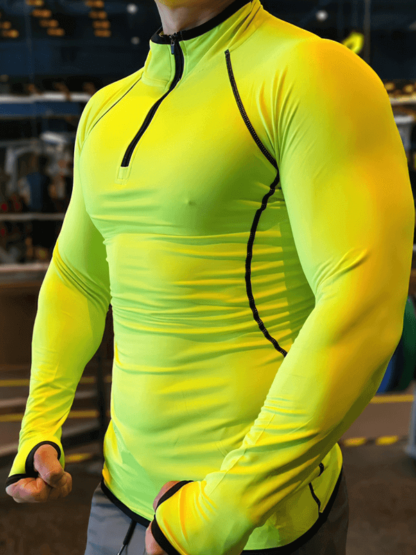 Men's yellow quarter-zip long sleeves compression bodybuilding top SF1950, made of spandex, worn in a gym setting.