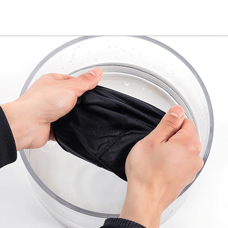 Hands washing a black cycling cap illustrating quick-dry material in action for SF1438