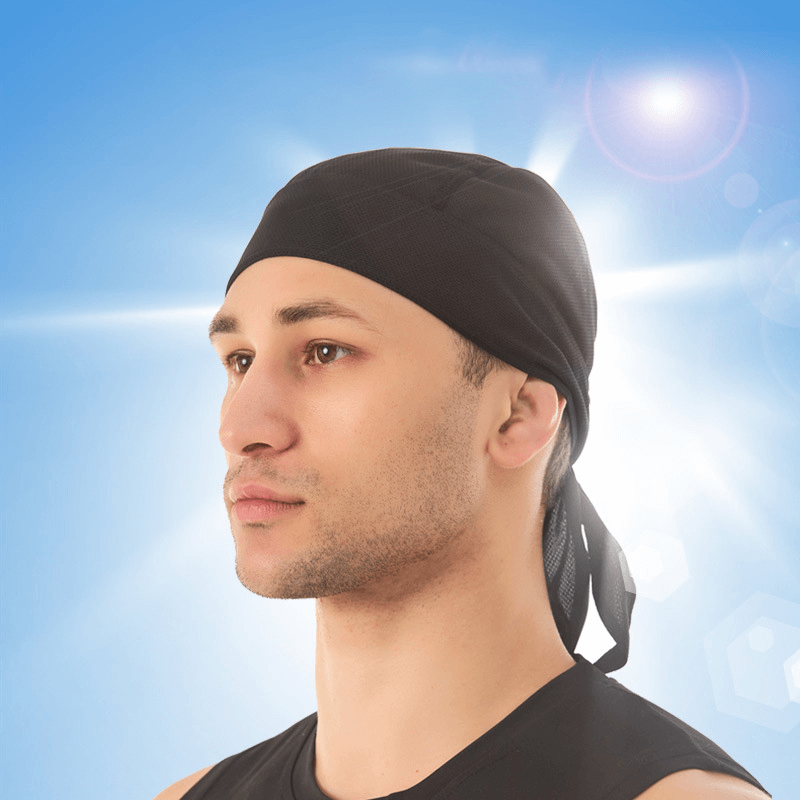 Man wearing a black Quick Dry Cycling Cap for UV protection in bright sunlight.