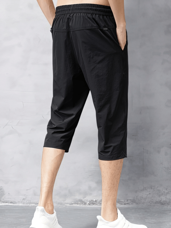 Back view of black Quick Dry Lightweight Men's Extended Shorts with side pockets, perfect for casual wear and mobility.