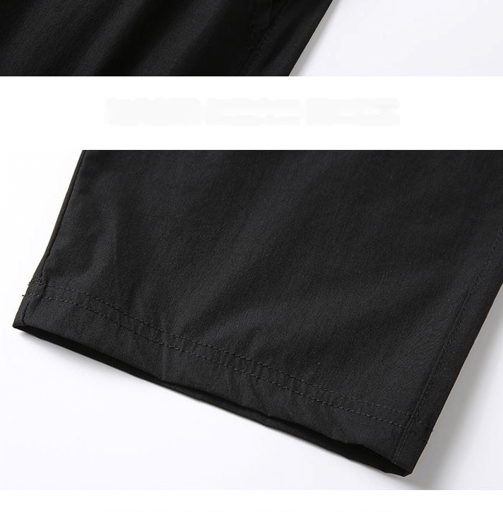Close-up of Quick Dry Lightweight Men's Extended Shorts showing side pocket and knee-length design in black fabric.