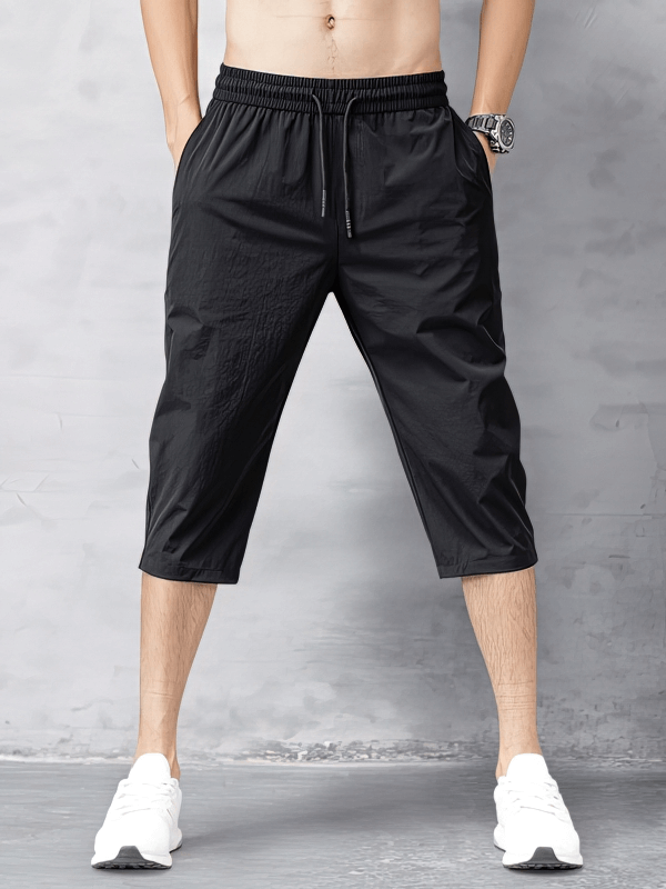 Black Quick Dry Men's Extended Shorts with Side Pockets, featuring lightweight nylon and spandex for comfort, shown knee-length.