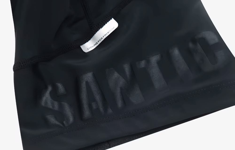 Close-up of SANTIC logo on quick-dry men's cycling jersey. Perfect for summer rides with breathable, moisture-wicking fabric.