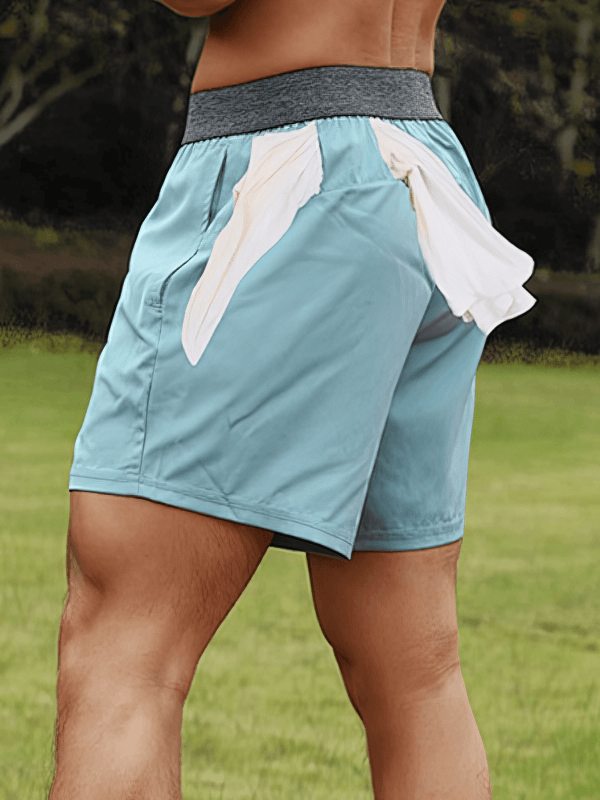 Blue quick-dry men's training shorts with white pockets, perfect for workouts, featuring a comfortable fit and elastic waistband.