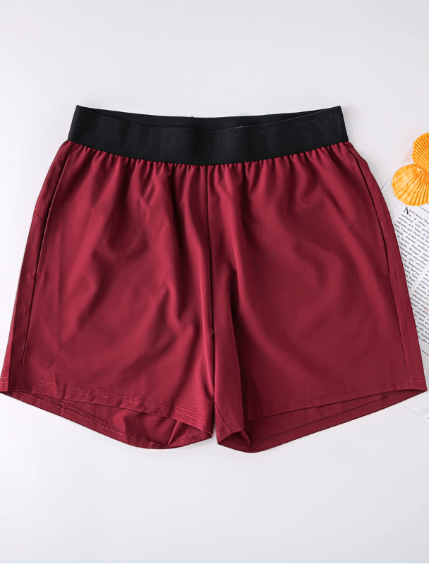 Quick Dry Men's Training Shorts with Pockets, sleek maroon design, elastic waistband, breathable fabric for cool workouts.