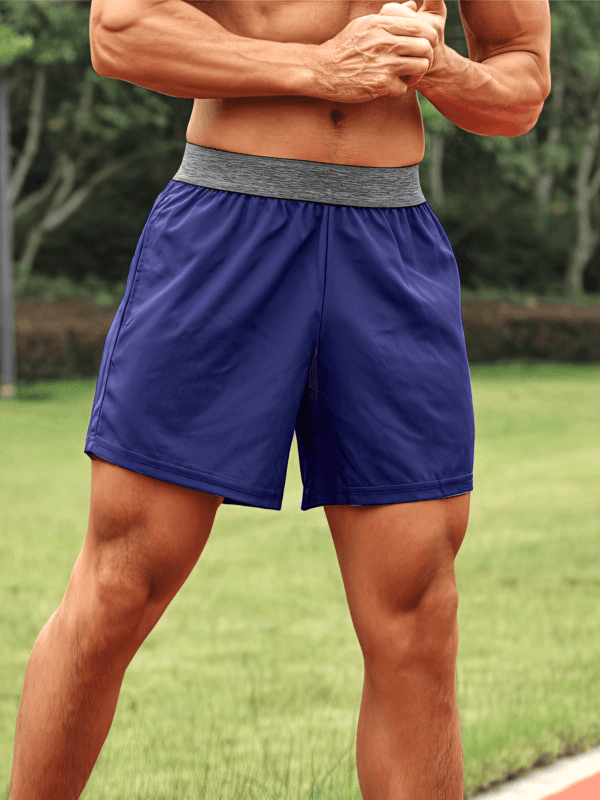 Man wearing Quick Dry Men's Training Shorts with Pockets - SF1437, showcasing breathable fabric and elastic waistband in outdoor setting.