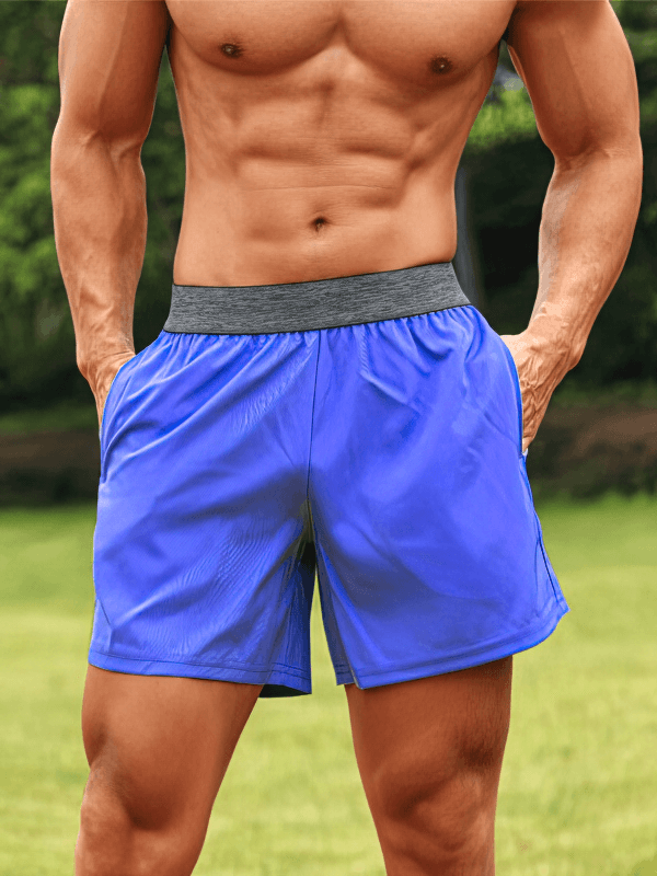 Man wearing Quick Dry Men's Training Shorts with Pockets, showcasing breathable fabric and comfortable fit in a vibrant outdoor setting.