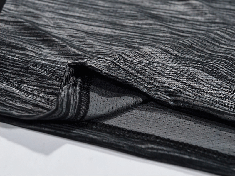 Close-up of black quick-dry polyester running t-shirt for men, highlighting breathable fabric and moisture-wicking features.