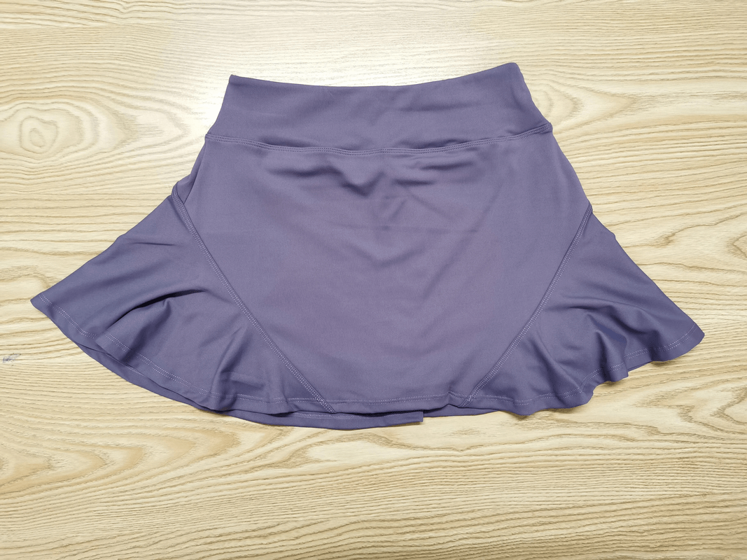 Purple quick-dry stacked skirt-shorts for female athletes, breathable nylon, solid pattern, ideal for sports like tennis and yoga.