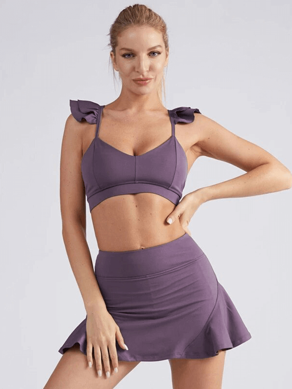 Purple quick dry sports bra and stacked skirt-shorts set for women, featuring sleeveless design and solid pattern, ideal for active wear.