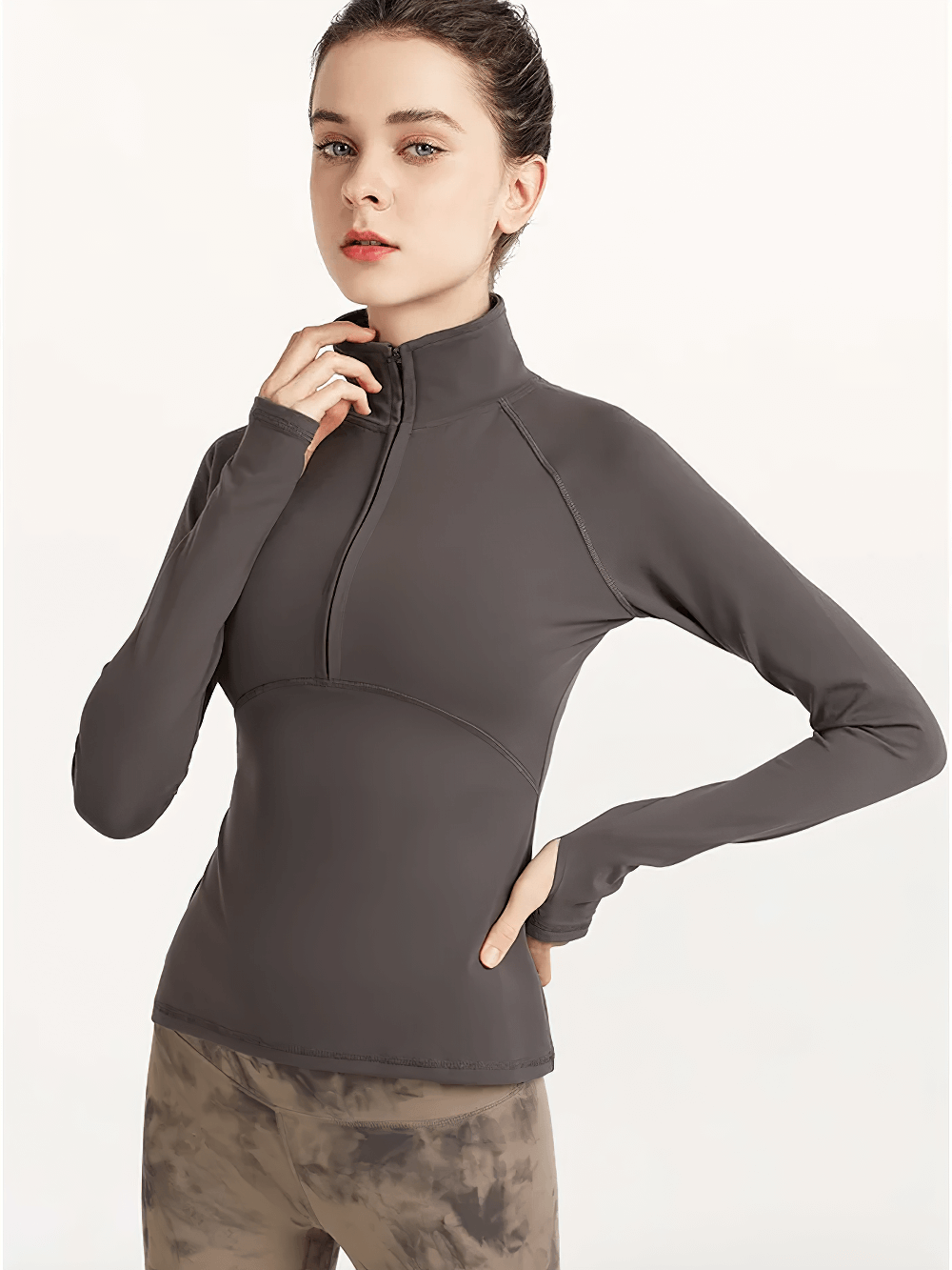 Woman wearing a Quick-Dry Yoga Shirt with Long Sleeves and Half-Zip in dark grey, showcasing its breathable and anti-pilling fabric.