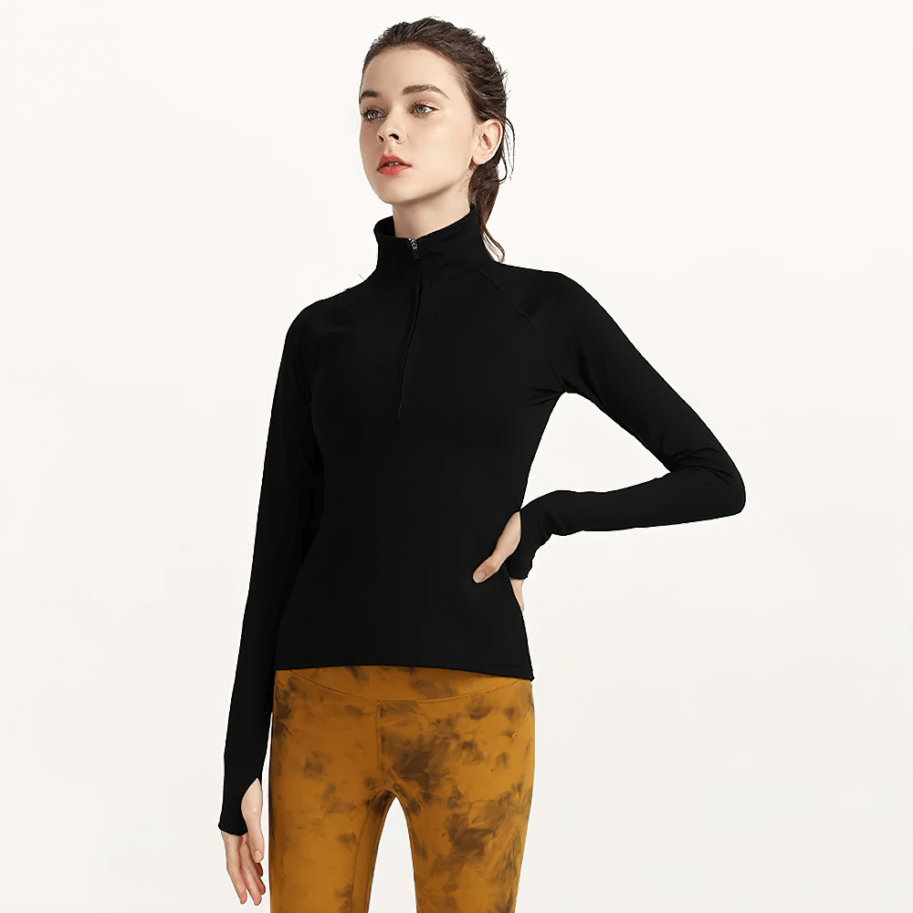 Woman wearing Quick-Dry Yoga Shirt with long sleeves and half-zip, perfect for yoga and fitness. Breathable nylon and spandex activewear top.