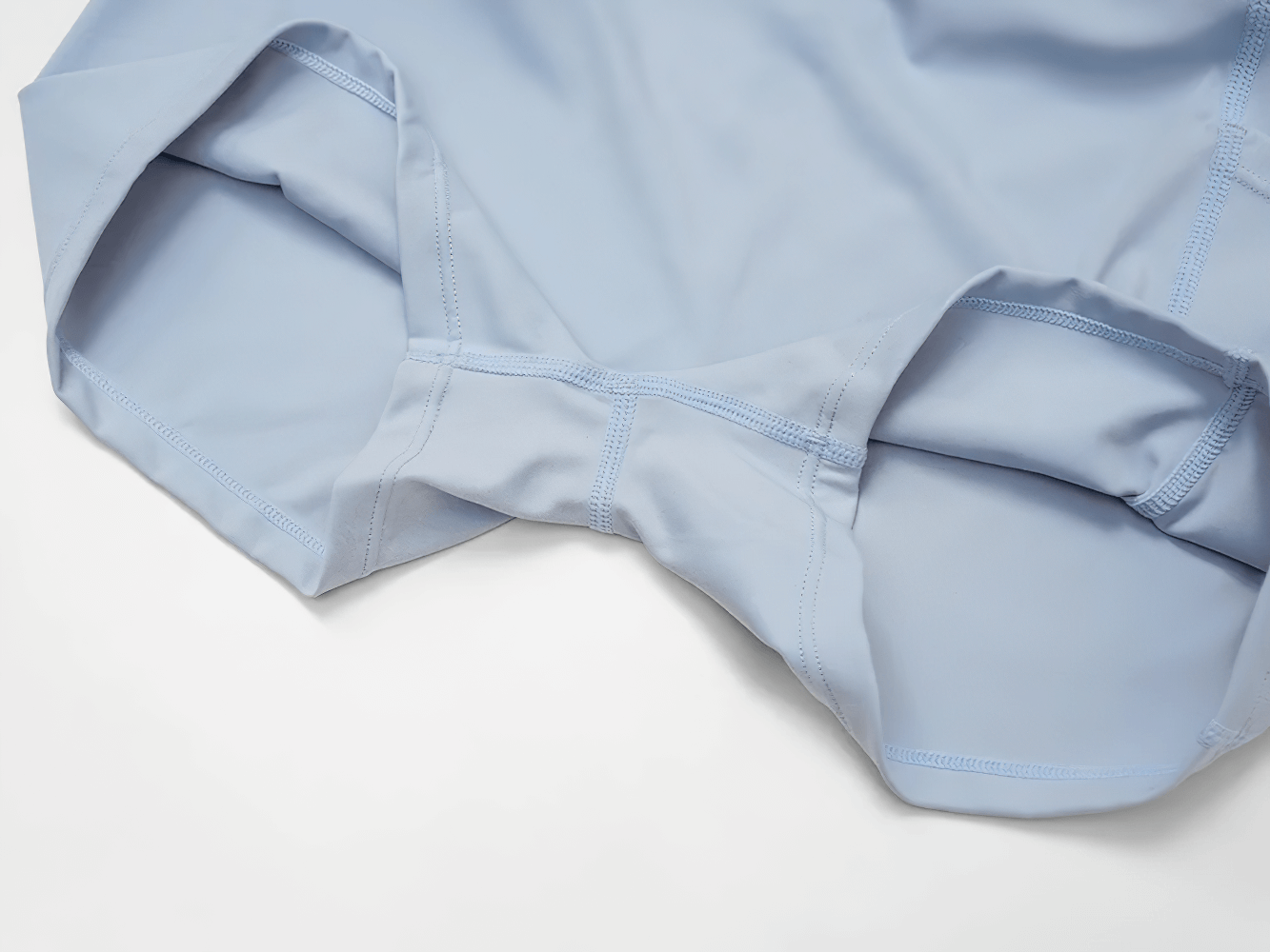 Alt Tag: Quick Dry Yoga Skirt for Badminton and Training - SF4402 close-up of light blue fabric with stitched seams and built-in shorts